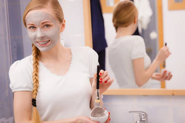 Woman with grey clay mud mask on her face — Stock Photo, Image