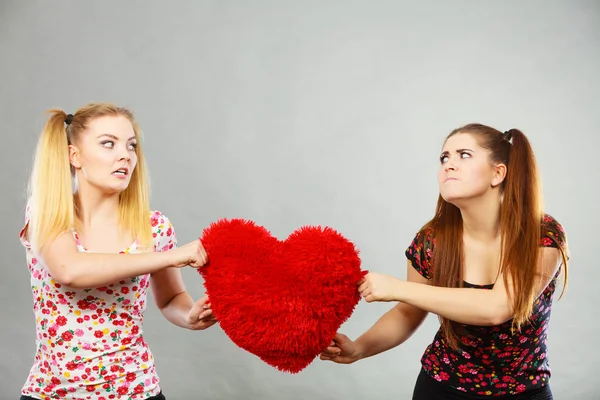 Two agressive women having argue fight holding heart — Stock Photo, Image