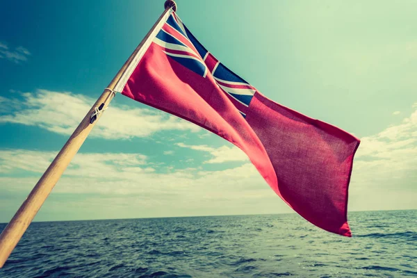 Uk red ensign the british maritime flag flown from yacht — Stock Photo, Image