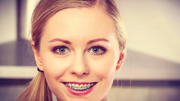 Happy smiling blonde woman having braces — Stock Photo, Image
