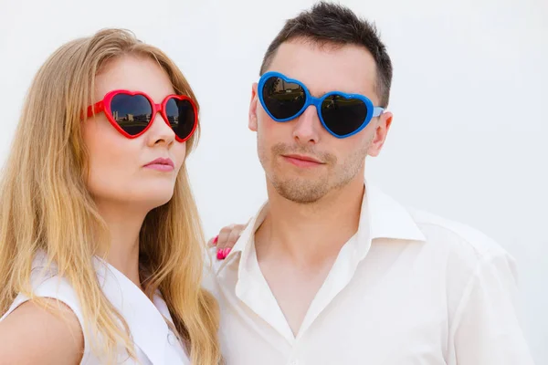 Man and woman wearing heart shape sunglasses — Stock Photo, Image