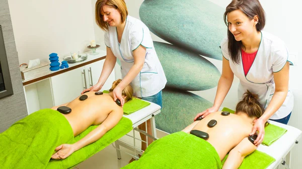 Massage with hot rocks stones in beautician — Stock Photo, Image