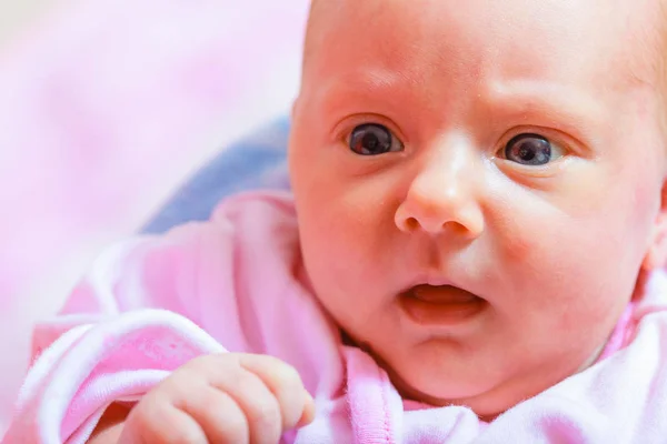 Newborn baby lying in pyjamas and towel — Stock Photo, Image