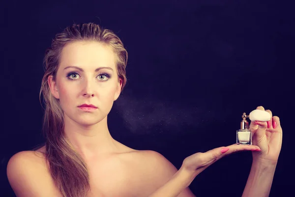Beautiful woman with holding and applying perfume — Stock Photo, Image