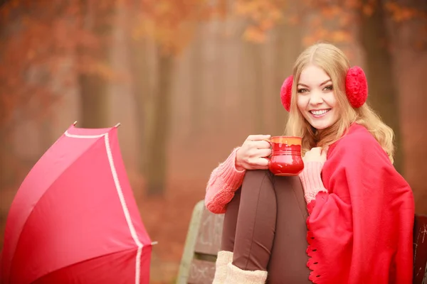 Chica en el parque de otoño disfrutando de bebida caliente — Foto de Stock