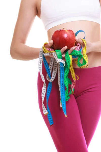 Closeup of woman holding apple and tape measures. — Stock Photo, Image