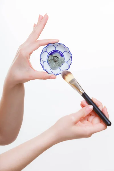 Woman mixing face mask in little porcelain bowl — Stock Photo, Image