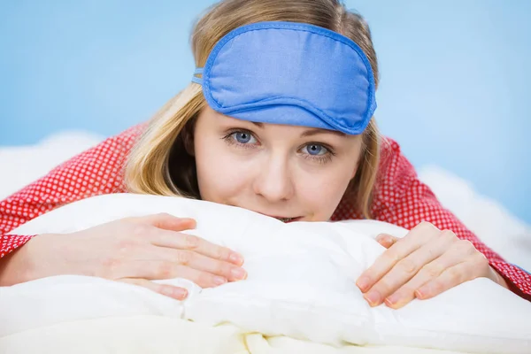 Young woman wearing sleeping eye band in bed — Stock Photo, Image