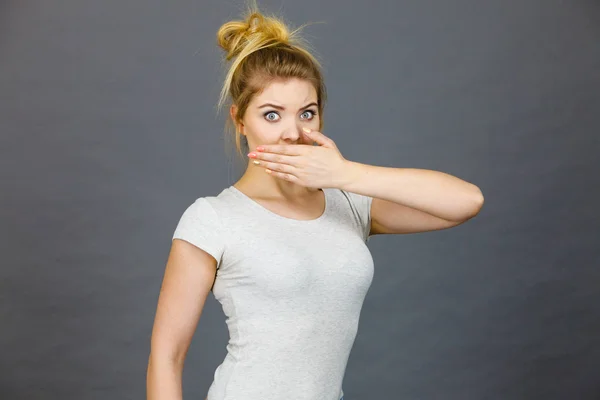 Woman covering her mouth with hand — Stock Photo, Image