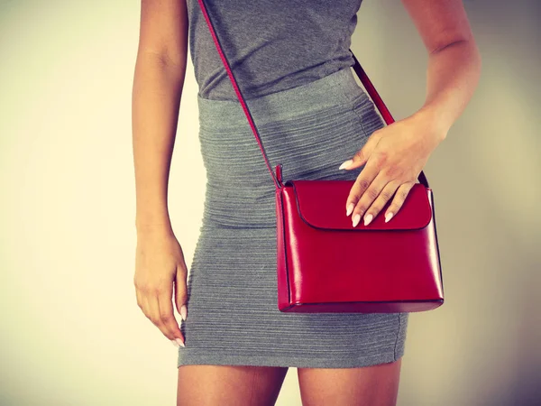 Slim girl in gray skirt with red handbag — Stock Photo, Image