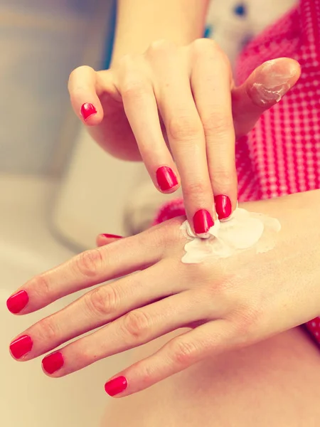 Mujer aplicando crema de manos en las manos — Foto de Stock