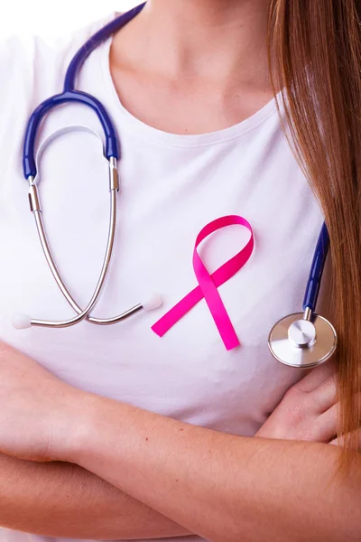 Pink ribbon and stethoscope on female chest — Stock Photo, Image