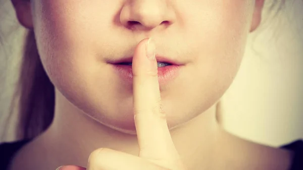 Woman showing silence gesture with finger — Stock Photo, Image