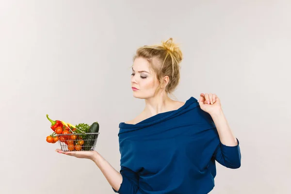 Woman with vegetables, thinking face expression