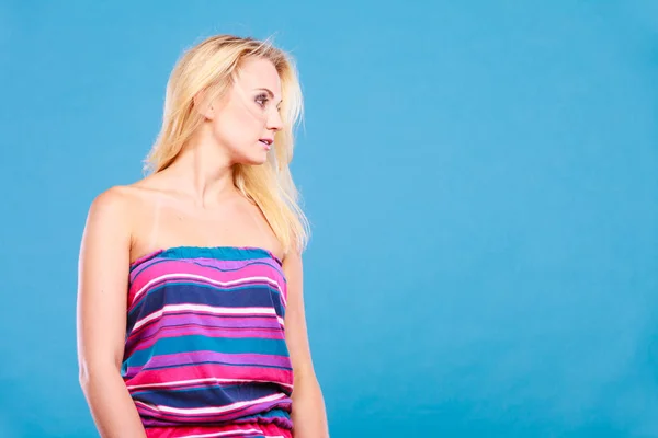 Blonde woman wearing short colorful striped dress — Stock Photo, Image