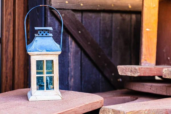 Little tealight lantern on wooden boards outside — Stock Photo, Image