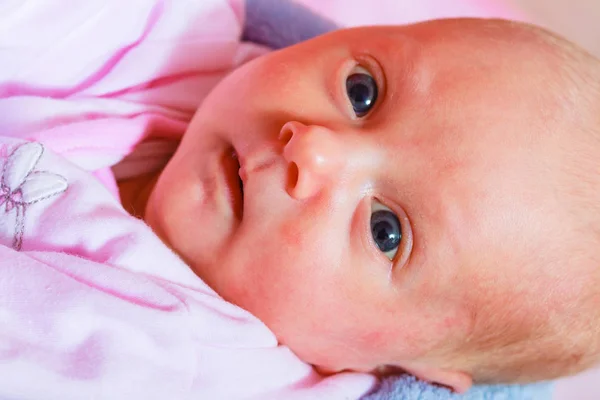 Newborn baby lying in pyjamas and towel — Stock Photo, Image