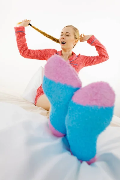 Vrouw in pyjama's dragen van harige warme sokken — Stockfoto