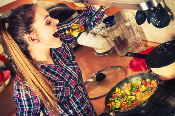 Vrouw die diepvriesgroenten bakt. Roerbak. — Stockfoto