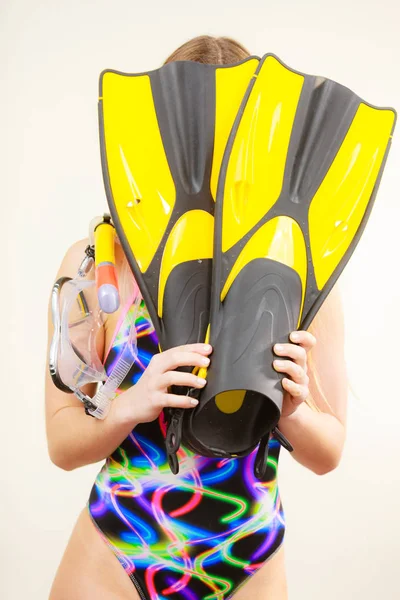 Woman covering her face with flippers having fun — Stock Photo, Image