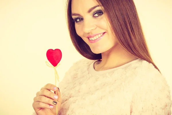 Beautiful woman holding heart shaped hand stick — Stock Photo, Image