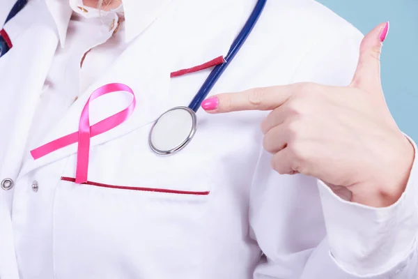 Pink ribbon with stethoscope on medical uniform. — Stock Photo, Image