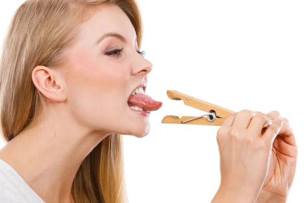 Blonde woman having tongue in clothespin — Stock Photo, Image