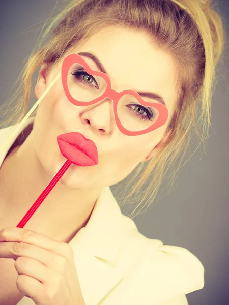 Happy elegant woman holding carnival accessoies on stick — Stock Photo, Image