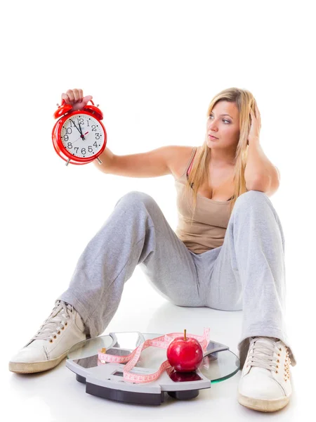 Woman holding apple, measuring tape and clock — Stock Photo, Image