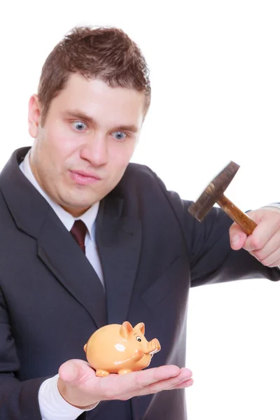 Man trying to break piggy bank with hammer — Stock Photo, Image