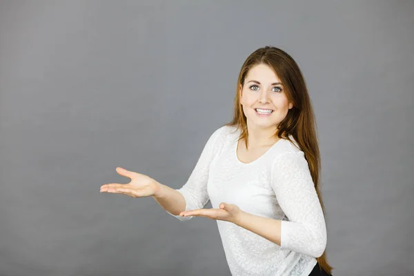 Happy woman presenting copyspace with hands — Stock Photo, Image