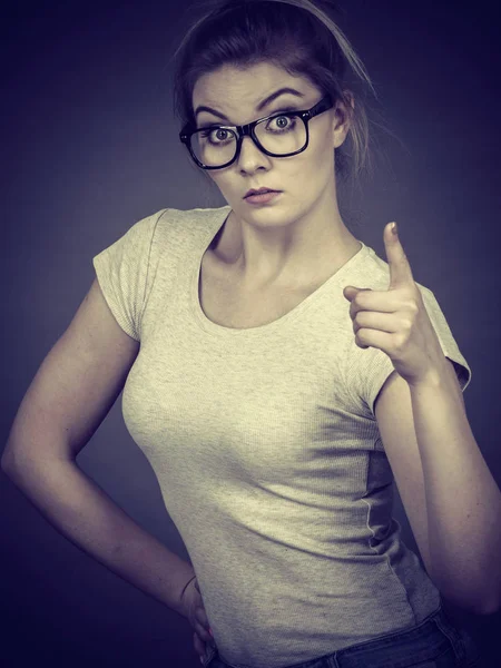 Woman wearing eyeglasses pointing at camera — Stock Photo, Image