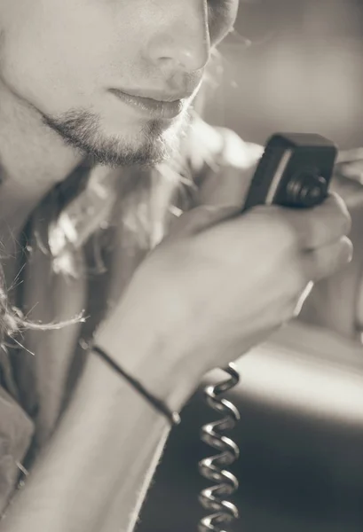 Young man driving car using cb radio — Stock Photo, Image