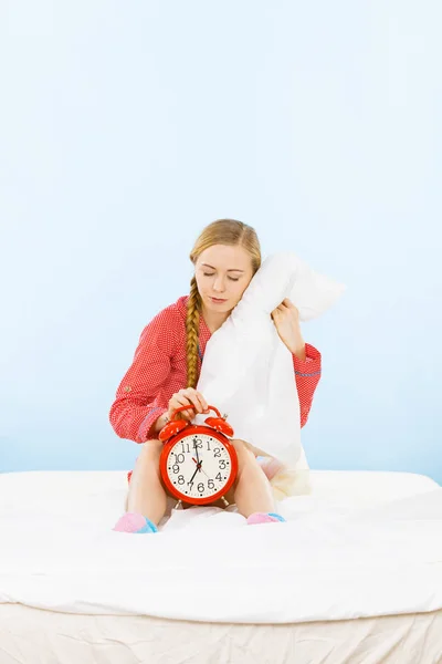 Young woman wearing pajamas hugging soft pillow — Stock Photo, Image