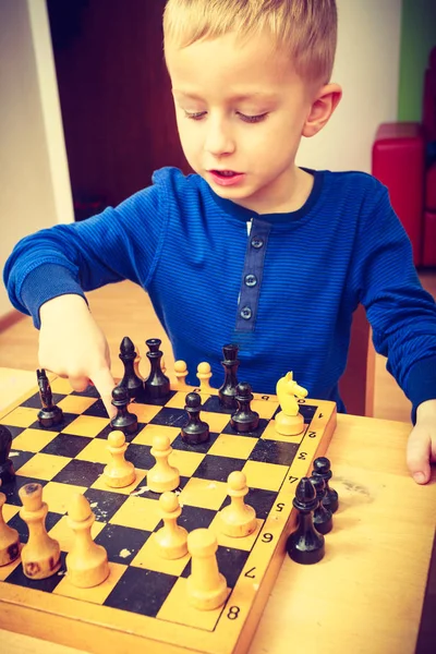 Young kid boy playing chess having fun — Stock Photo, Image