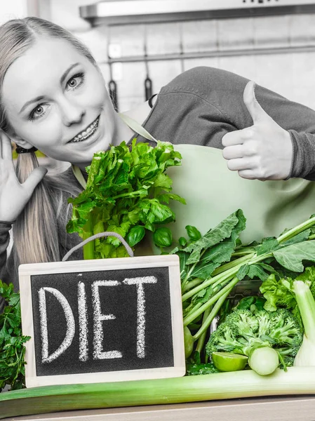 Woman in kitchen having green diet vegetables — Stock Photo, Image