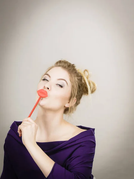 Funny woman holding big red lips on stick — Stock Photo, Image