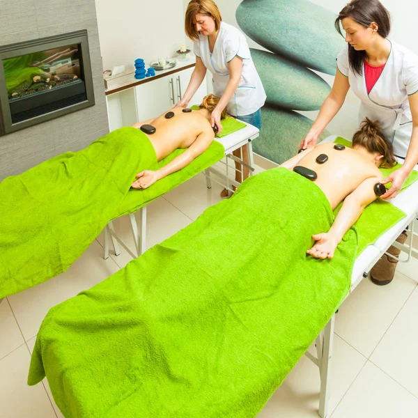 Massage with hot rocks stones in beautician — Stock Photo, Image