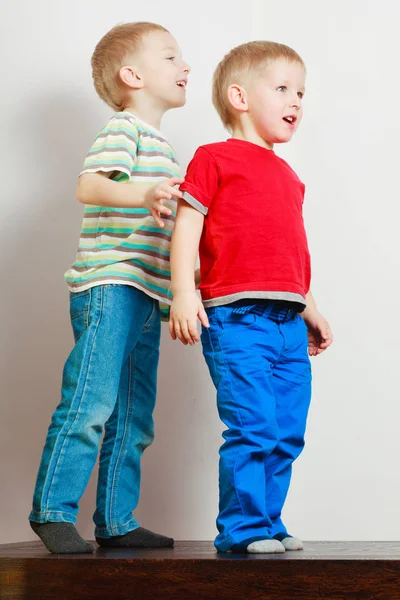 Två små pojkar syskon spelar tillsammans på bord — Stockfoto