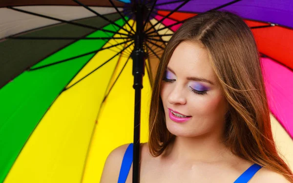 Woman standing under colorful rainbow umbrella — Stock Photo, Image