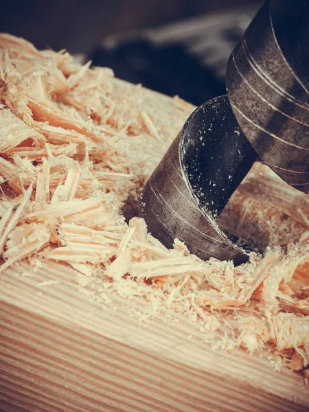 Metal machine drilling in wooden board — Stock Photo, Image