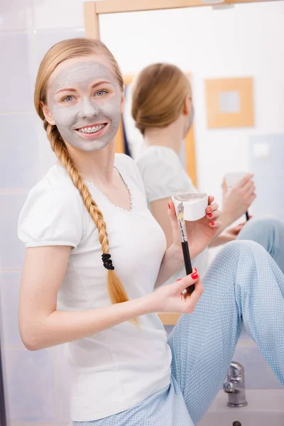 Woman with grey clay mud mask on her face — Stock Photo, Image