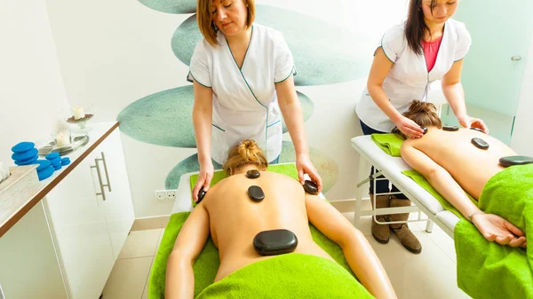 Massage with hot rocks stones in beautician — Stock Photo, Image