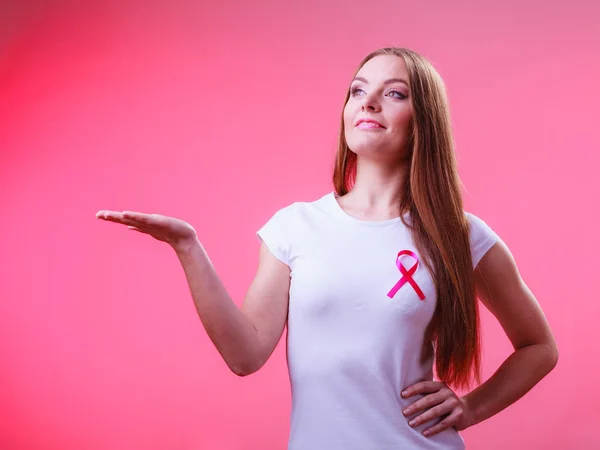 Woman pink cancer ribbon on chest holds open hand — Stock Photo, Image