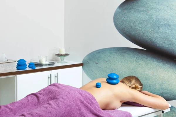 Massage with cupping glass in beautician