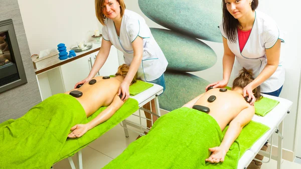 Massage with hot rocks stones in beautician — Stock Photo, Image