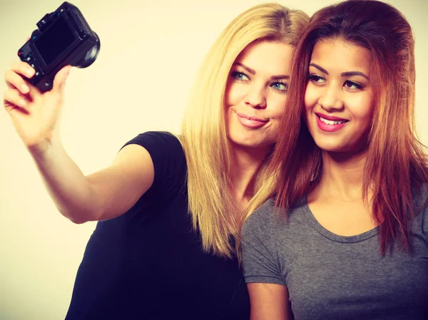 Two models girls taking self picture with camera — Stock Photo, Image