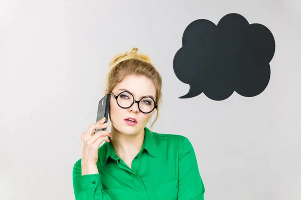 Деловая женщина разговаривает по телефону с мыслящими пузырями — стоковое фото