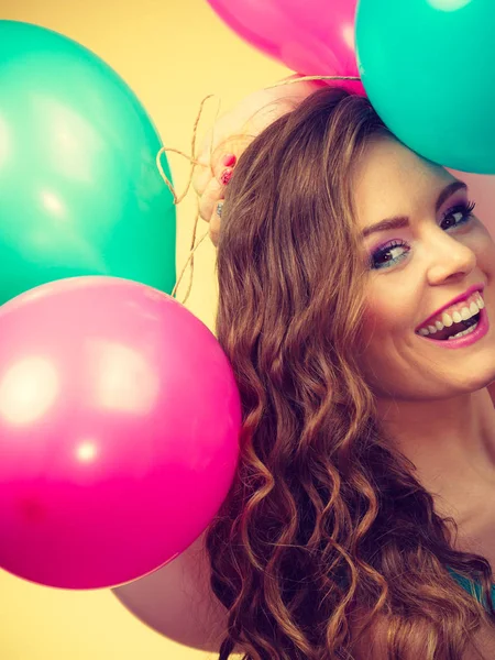 Mujer sosteniendo racimo de globos de colores — Foto de Stock