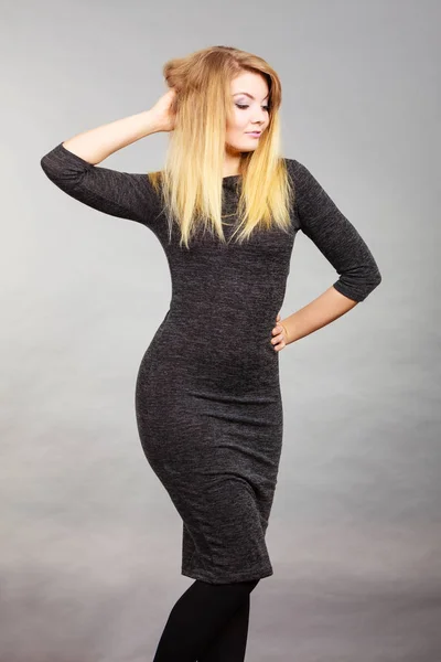 Attractive blonde woman wearing tight black dress — Stock Photo, Image